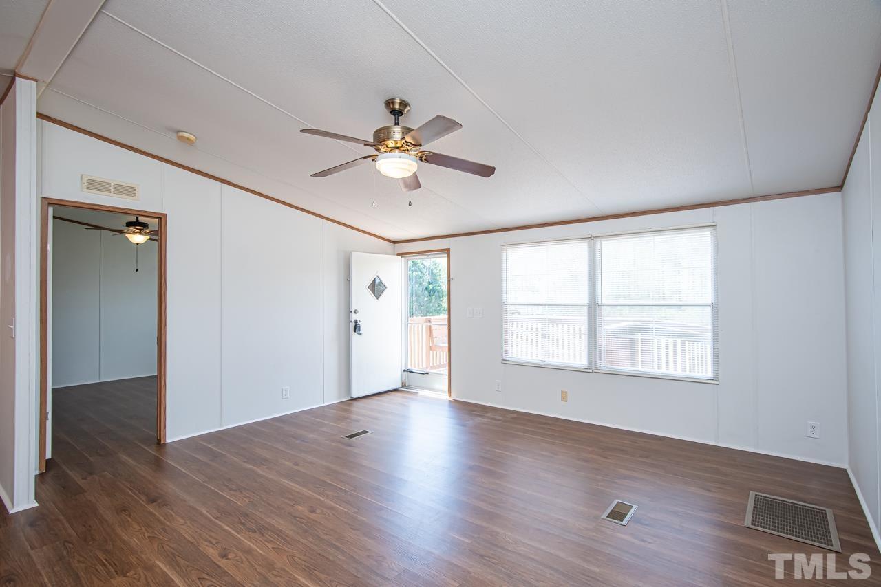 1545 Cheves Road Zebulon, NC 27597 - Photo 23 of 28 a view of an empty room with wooden floor and a window