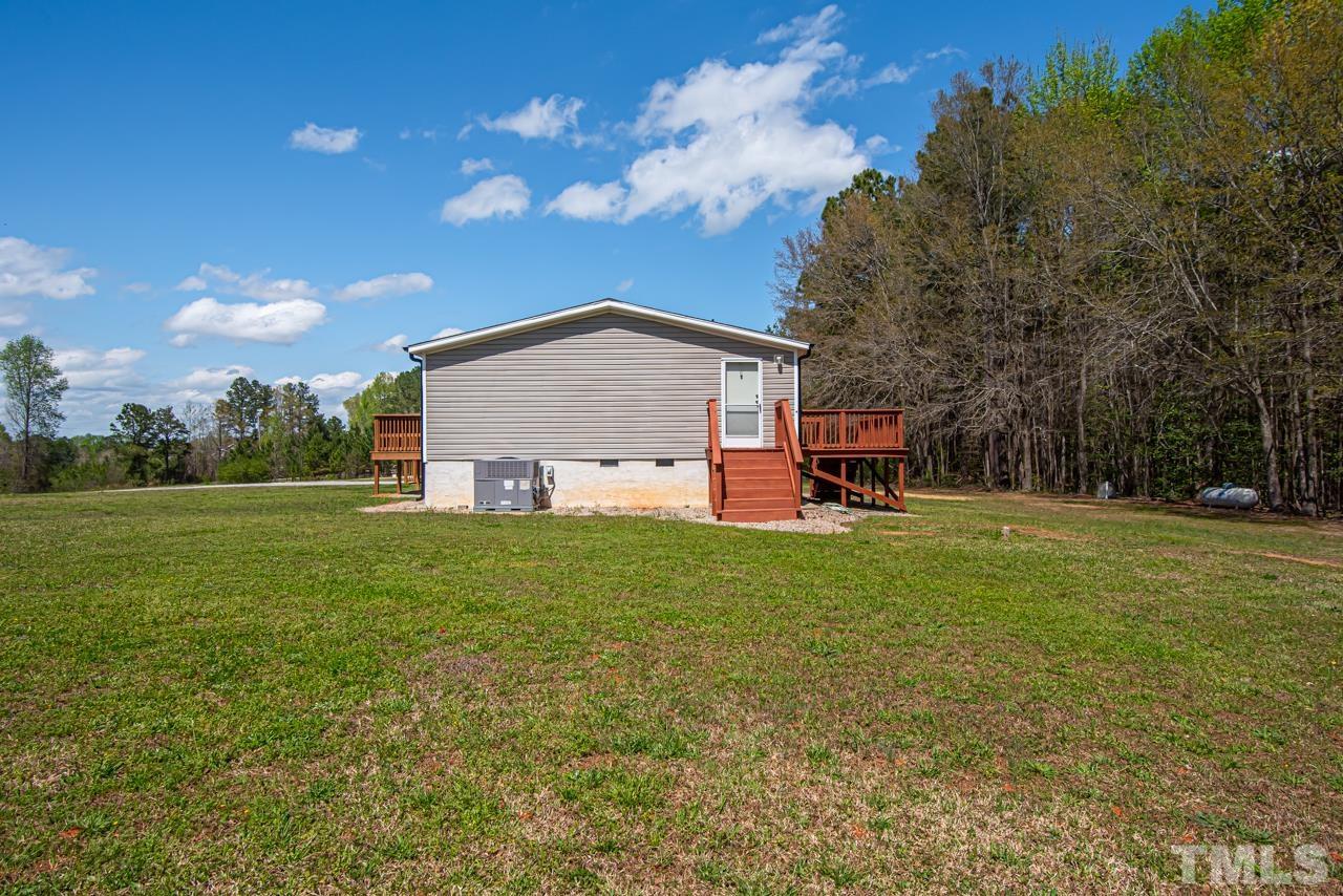 1545 Cheves Road Zebulon, NC 27597 - Photo 25 of 28 a view of a house with a yard
