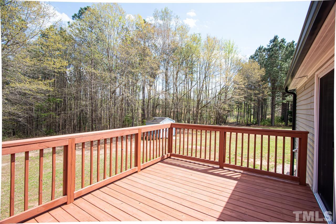 1545 Cheves Road Zebulon, NC 27597 - Photo 7 of 28 a balcony with wooden floor and fence