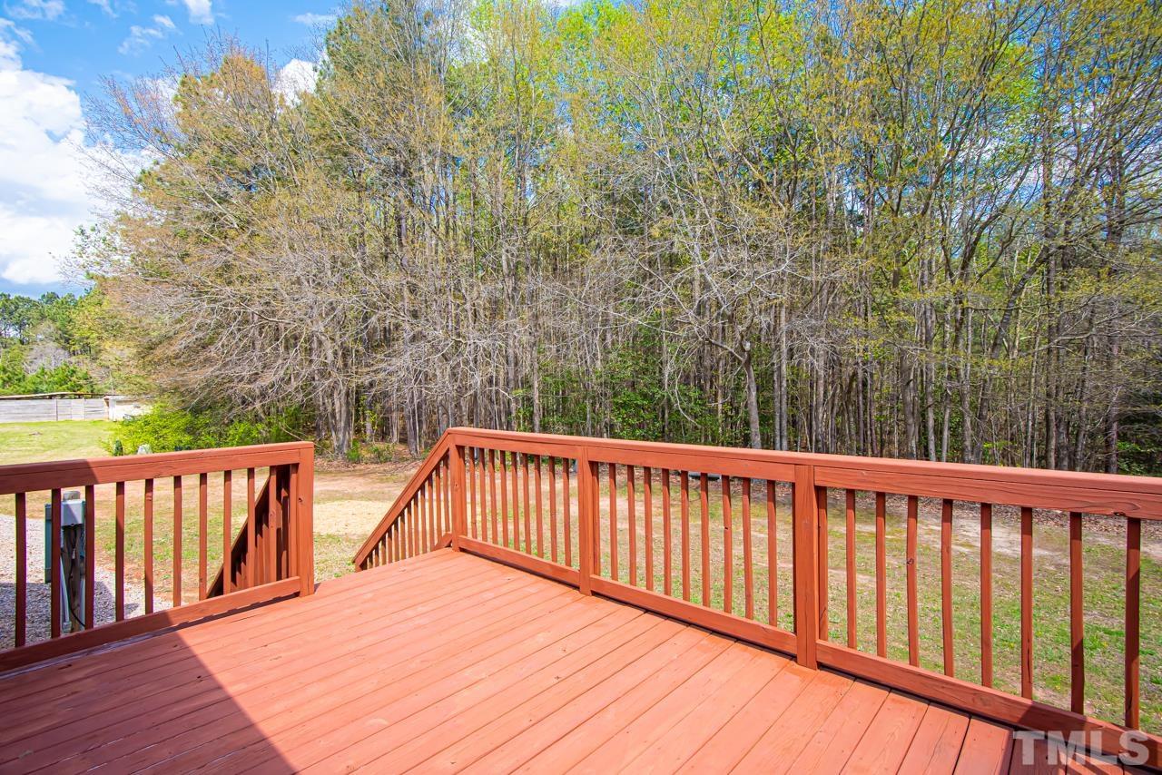 1545 Cheves Road Zebulon, NC 27597 - Photo 8 of 28 a balcony with wooden floor and fence