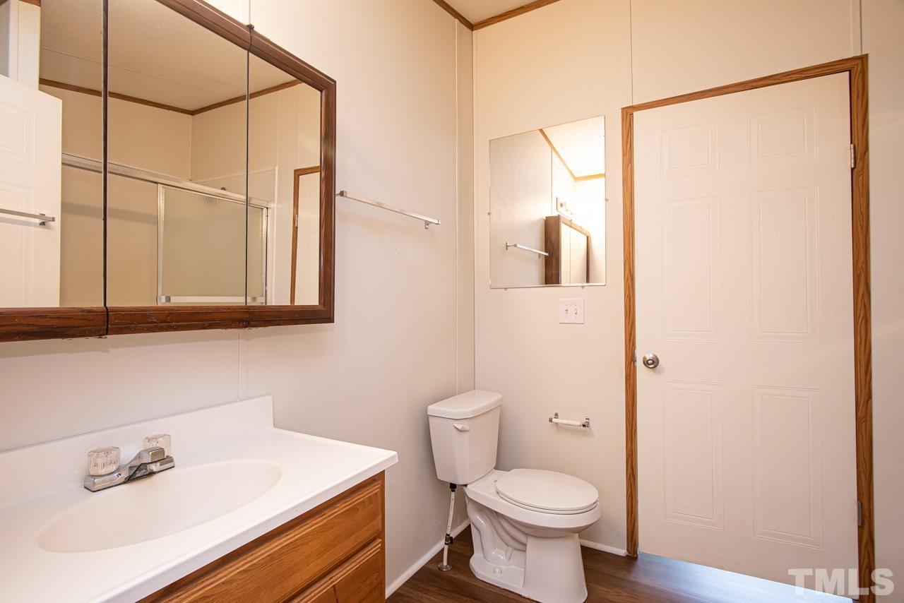 1545 Cheves Road Zebulon, NC 27597 - Photo 9 of 28 a bathroom with a sink a toilet and shower