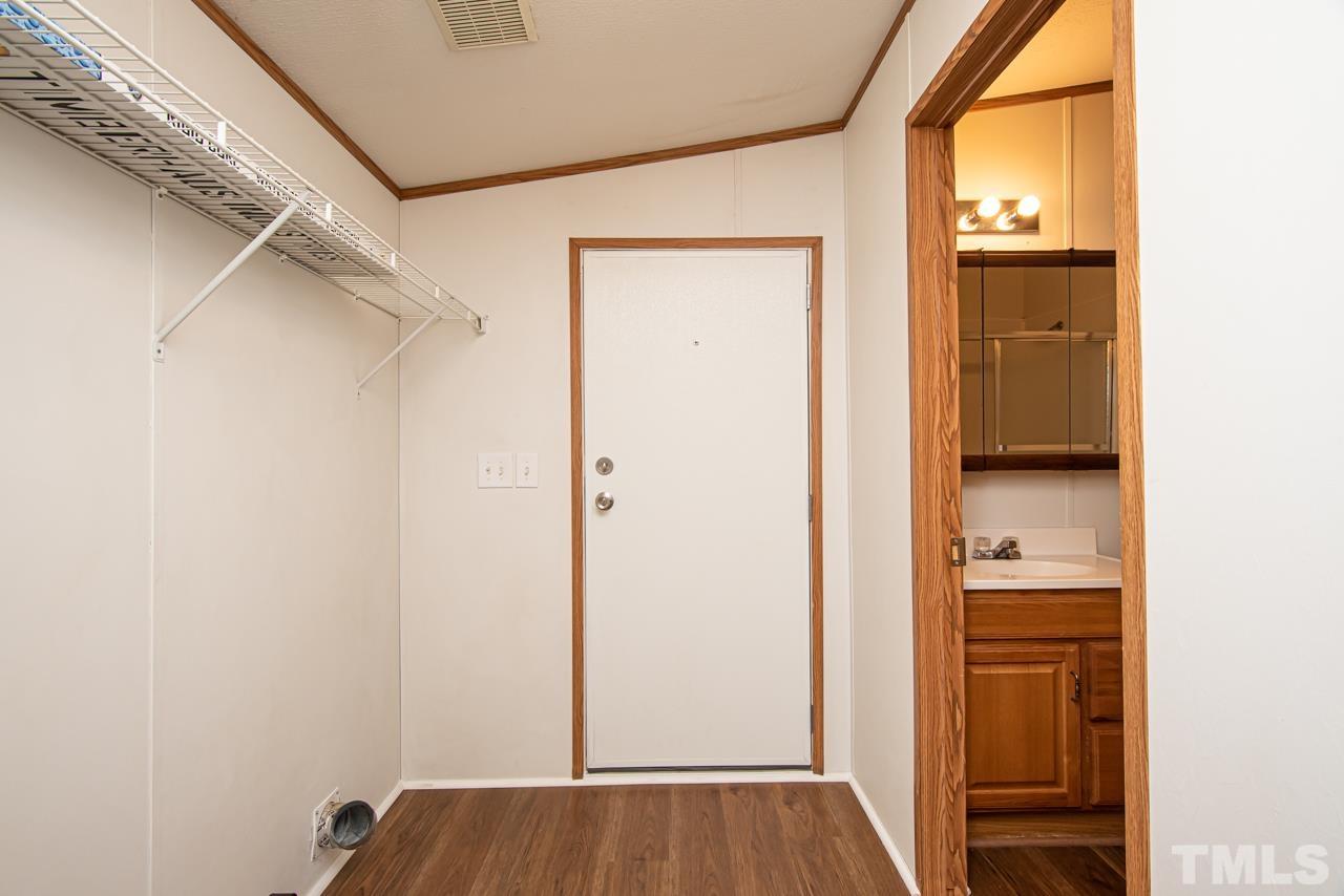 1545 Cheves Road Zebulon, NC 27597 - Photo 10 of 28 a view of walk in closet with wooden floor