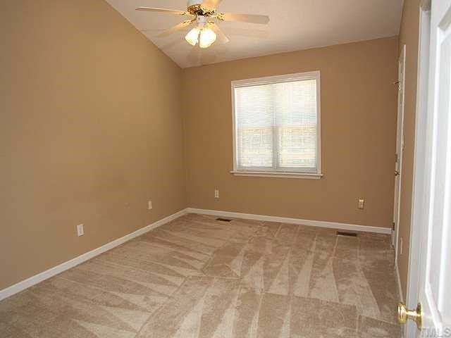 4108 Rockside Hills Drive Raleigh, NC 27603 - Photo 5 of 9 an empty room with windows and fan
