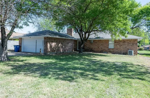 a front view of house with yard and trees