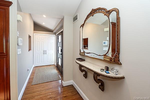 32 Randy Lane Plainview, NY 11803 - Photo 3 of 26 a room with a mirror and hardwood floor