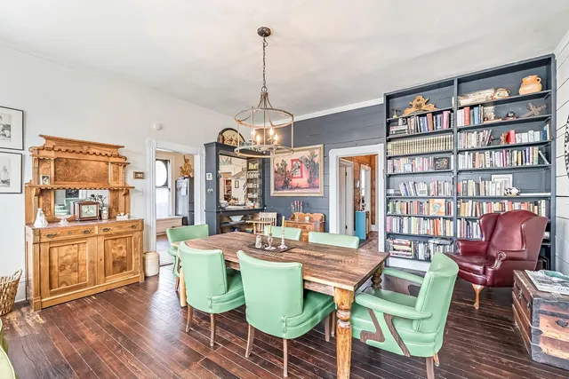 a view of a dining room with furniture and a chandelier