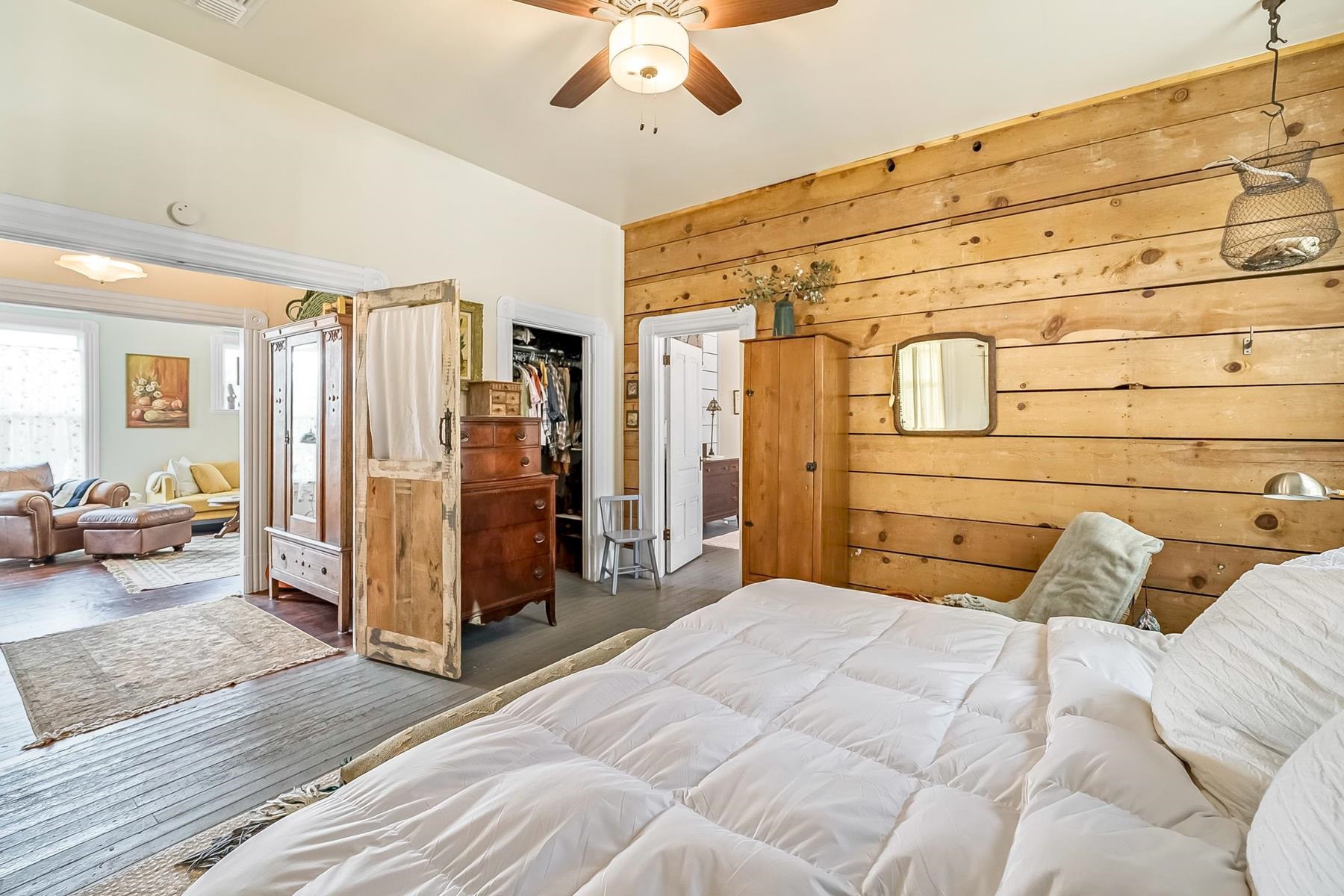 201 Front Street Loyalton, CA 96118 - Photo 19 of 28 a bedroom with a large bed a chandelier and a couch