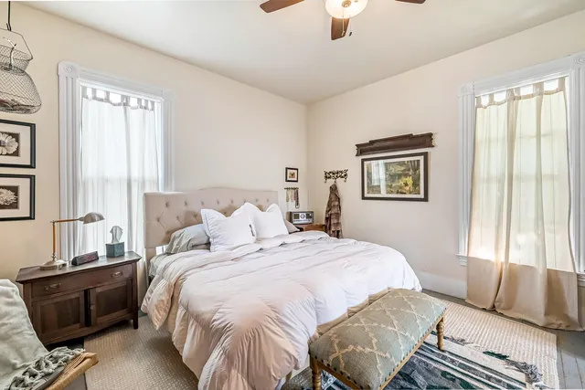 a bedroom that has a bed and a table in it