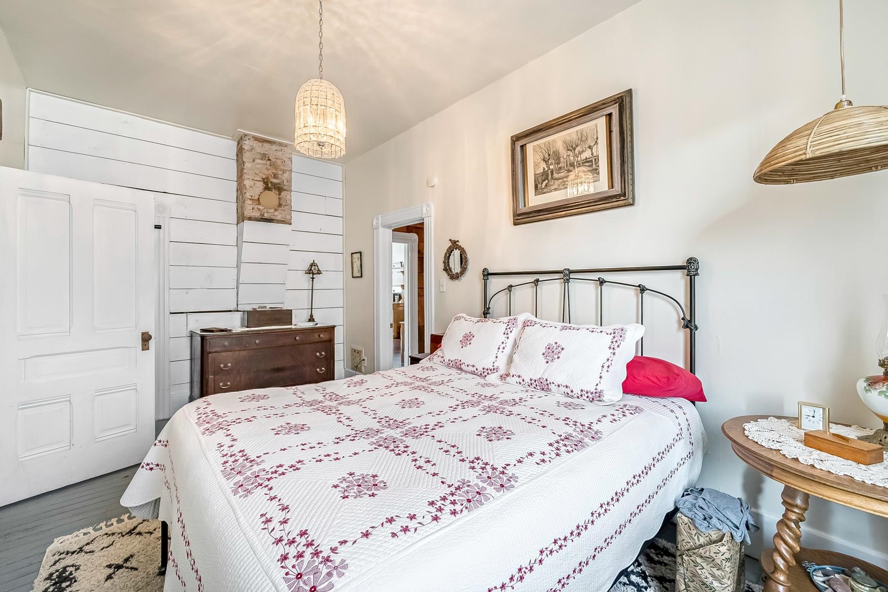 201 Front Street Loyalton, CA 96118 - Photo 22 of 28 a bedroom with a bed and a chandelier