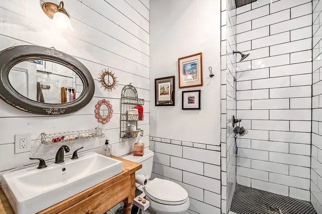 a bathroom with a sink a mirror and a bathtub