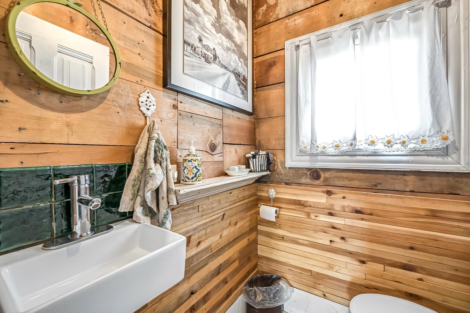 201 Front Street Loyalton, CA 96118 - Photo 24 of 28 a bathroom with a sink a mirror and a bathtub