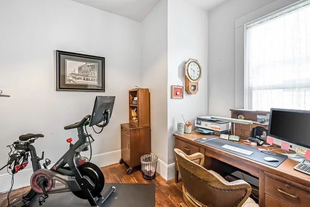 a very nice looking room with a large window and wooden floor