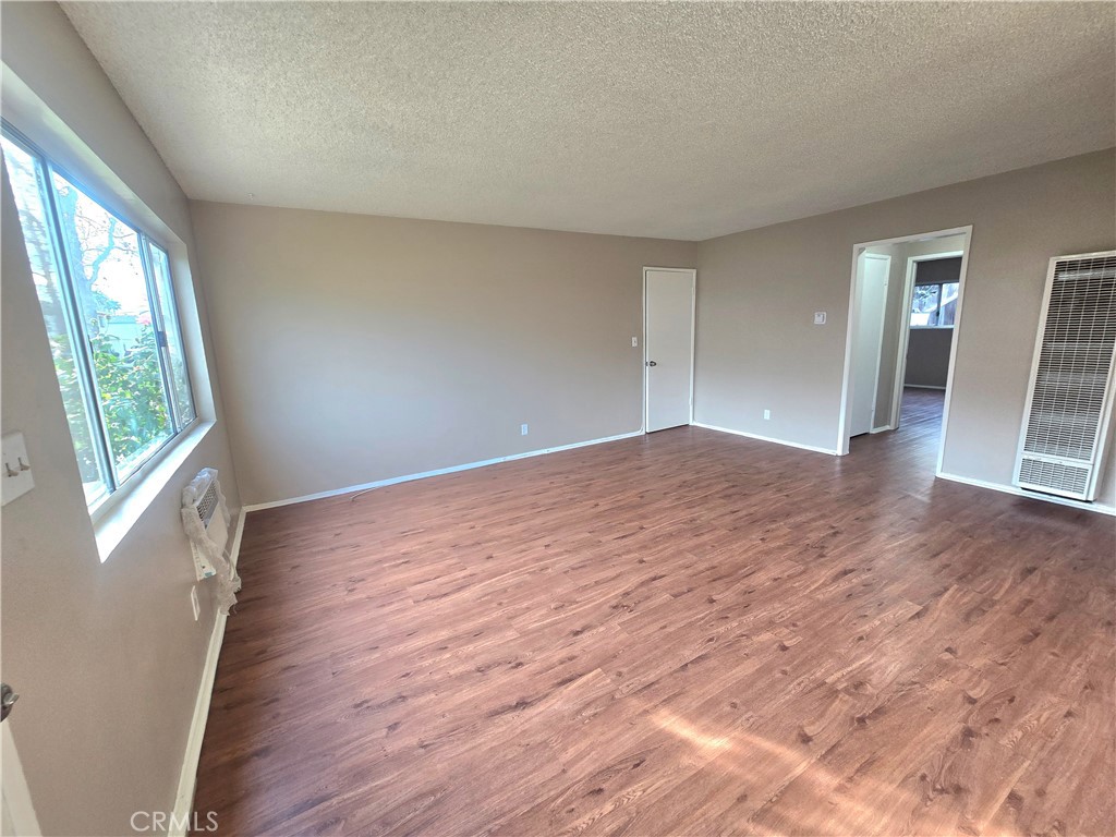 448 North Terry Way, Unit B Upland, CA 91786 - Photo 6 of 17 a view of empty room with wooden floor and fan