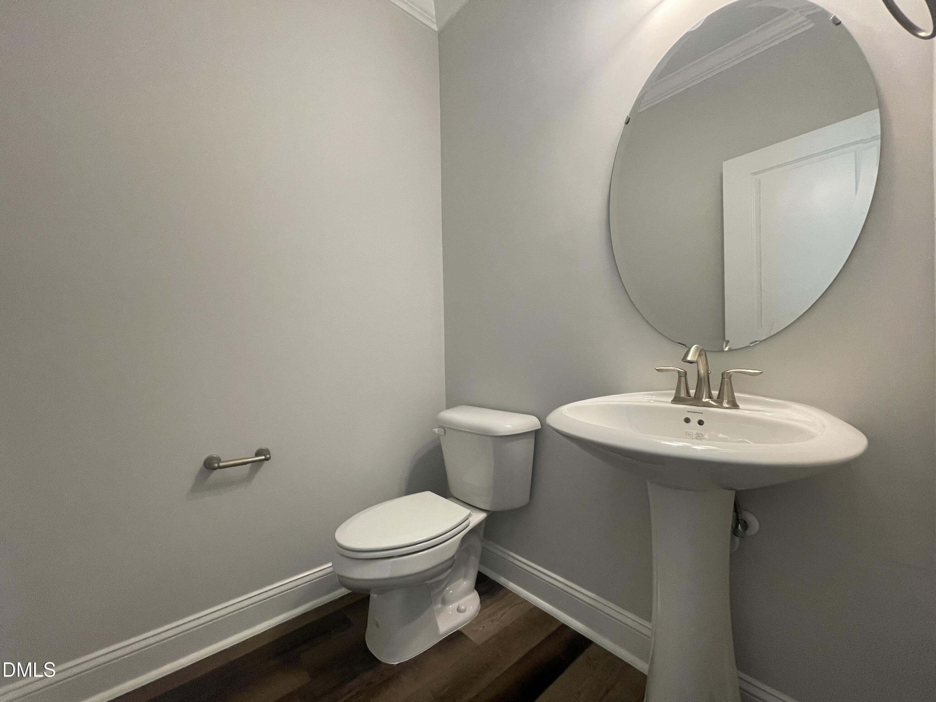 152 Baymouth Lane Raleigh, NC 27610 - Photo 13 of 34 a bathroom with a toilet a sink and mirror