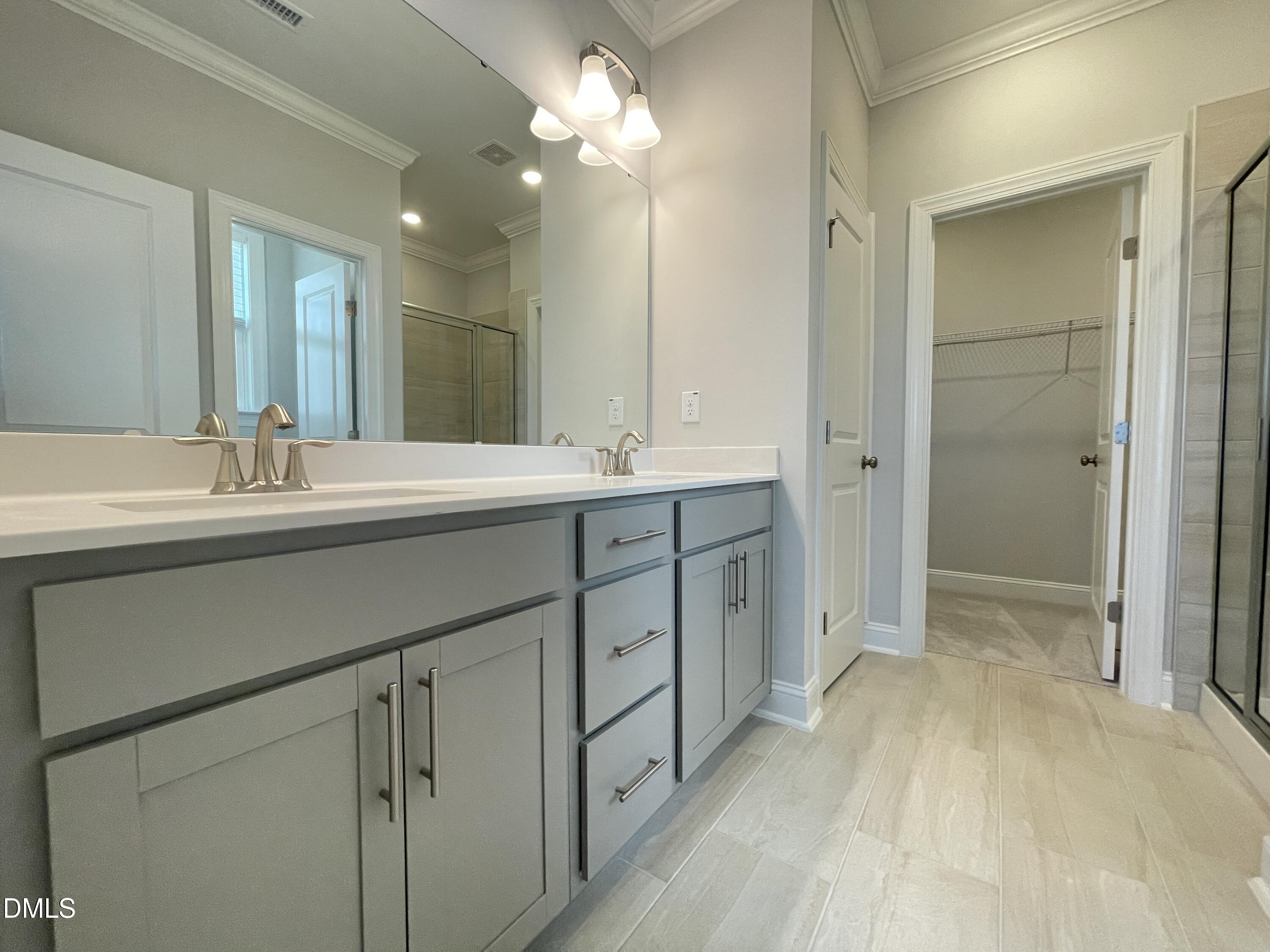 152 Baymouth Lane Raleigh, NC 27610 - Photo 18 of 34 a spacious bathroom with a double vanity sink mirror and shower