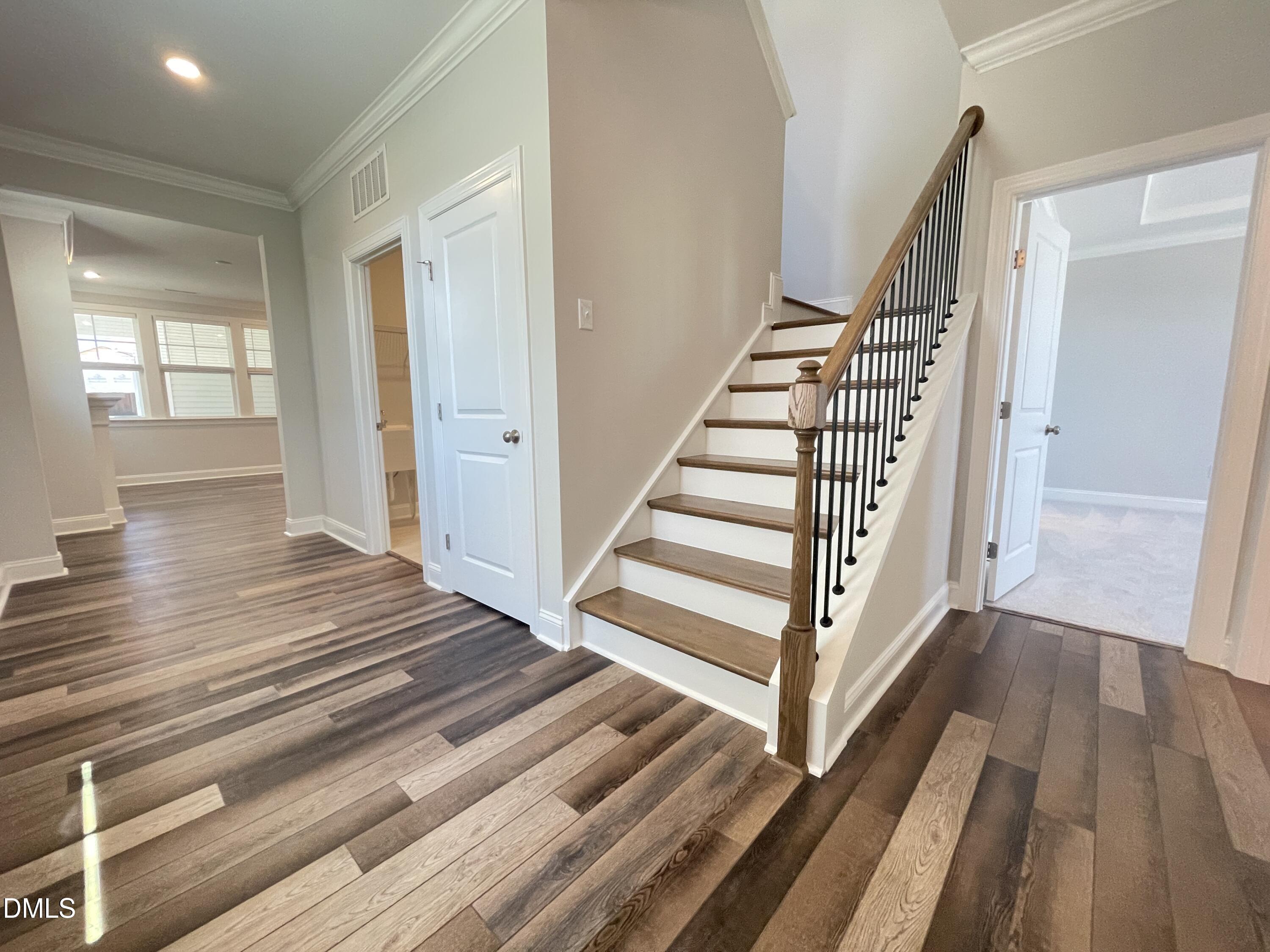 152 Baymouth Lane Raleigh, NC 27610 - Photo 2 of 34 a view of a hallway with wooden floor and stairs