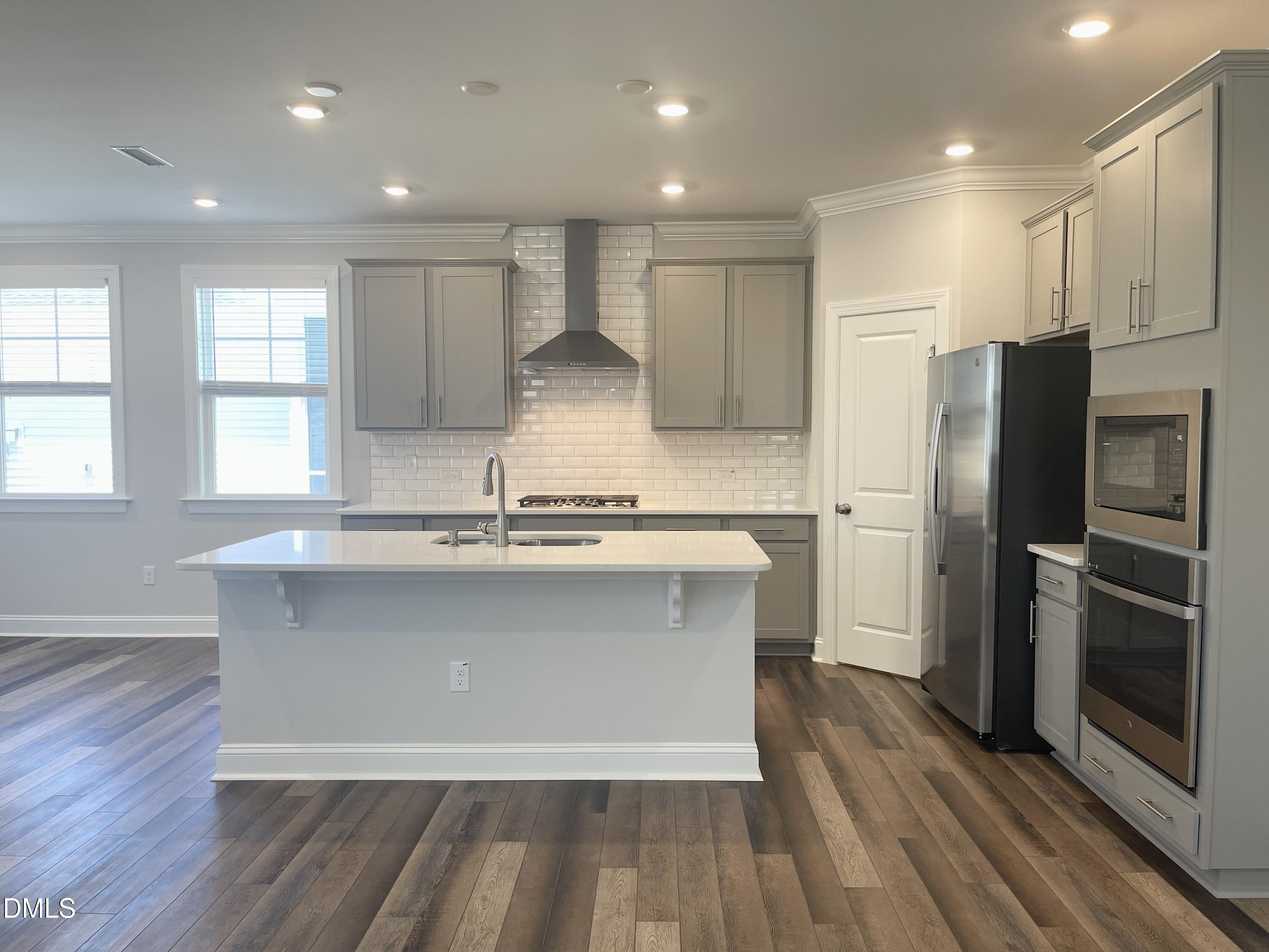 152 Baymouth Lane Raleigh, NC 27610 - Photo 9 of 34 a large kitchen with stainless steel appliances granite countertop a stove a sink and a refrigerator