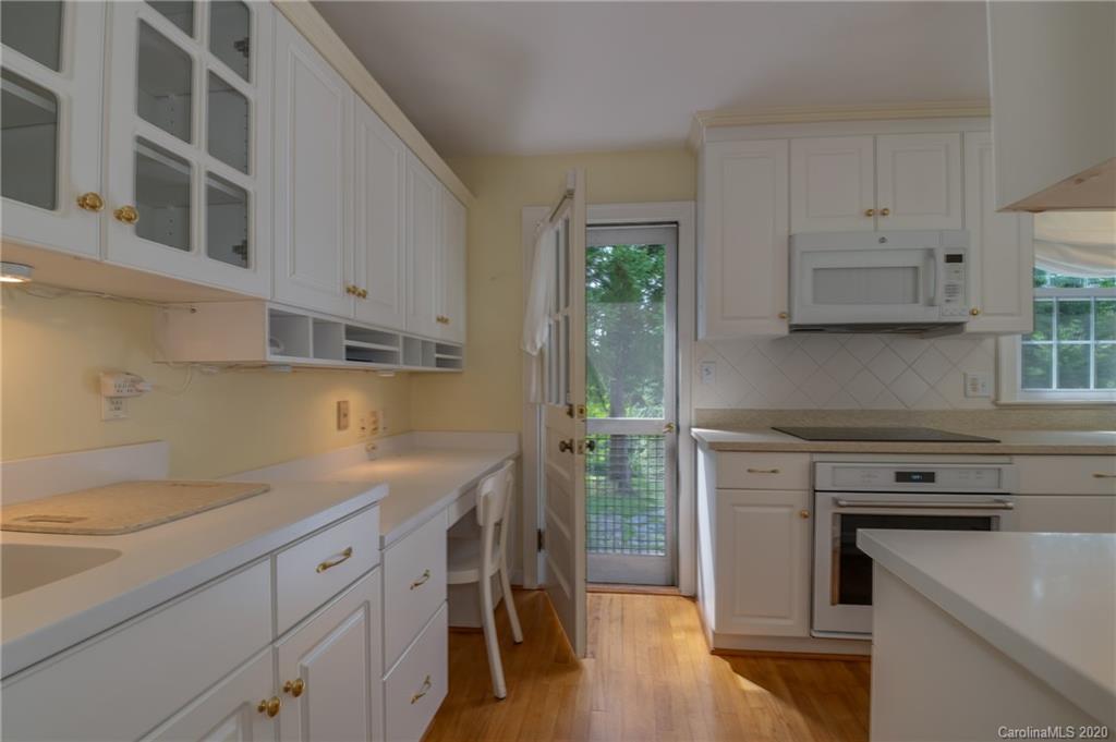 300 Doubleday Road Tryon, NC 28782 - Photo 13 of 38 a kitchen with cabinets appliances and wooden floor
