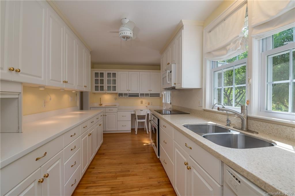 300 Doubleday Road Tryon, NC 28782 - Photo 14 of 38 a kitchen with granite countertop a sink and white cabinets