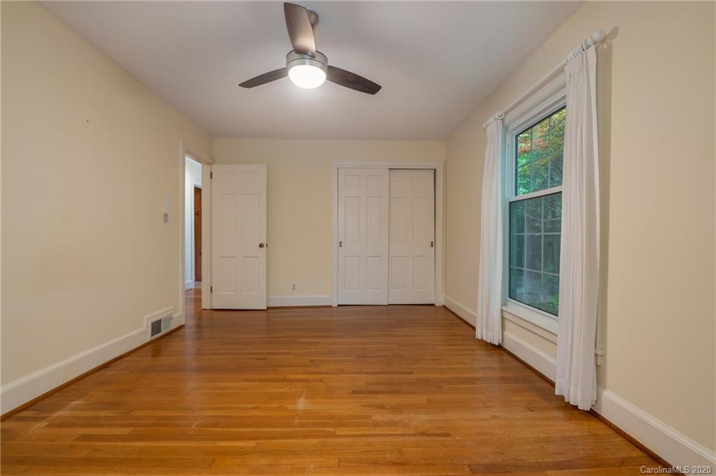300 Doubleday Road Tryon, NC 28782 - Photo 24 of 38 an empty room with wooden floor cabinet and windows