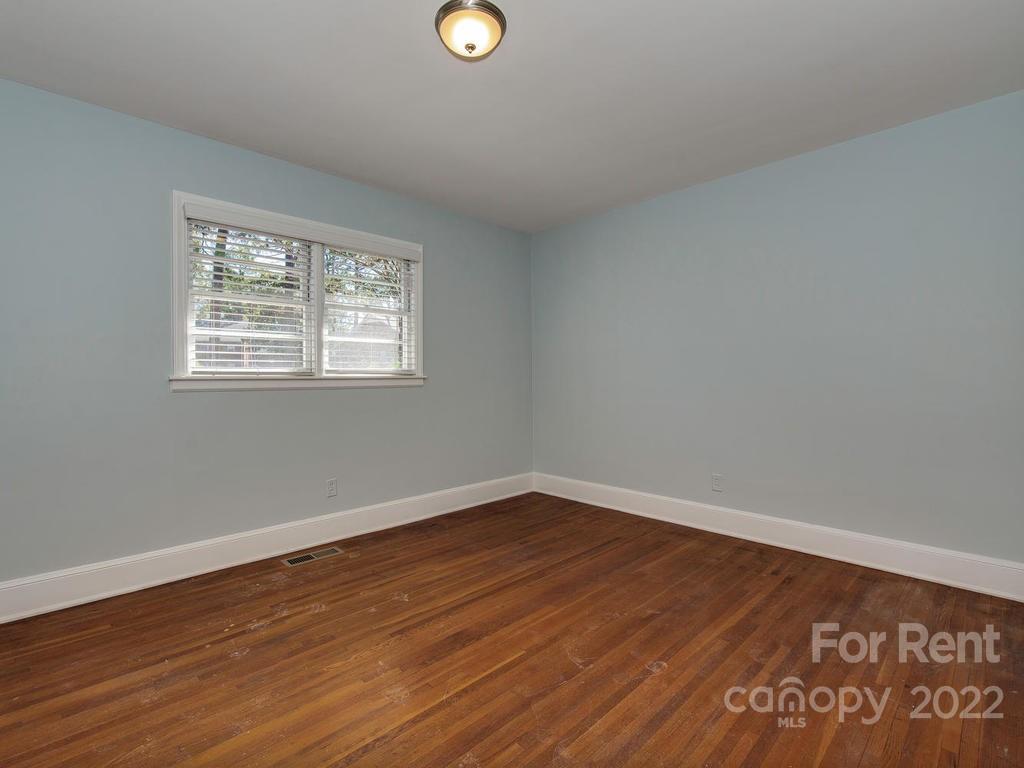 943 B Norland Road, Unit B Charlotte, NC 28205 - Photo 12 of 17 an empty room with wooden floor and windows