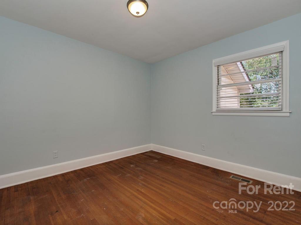 943 B Norland Road, Unit B Charlotte, NC 28205 - Photo 13 of 17 an empty room with wooden floor and windows