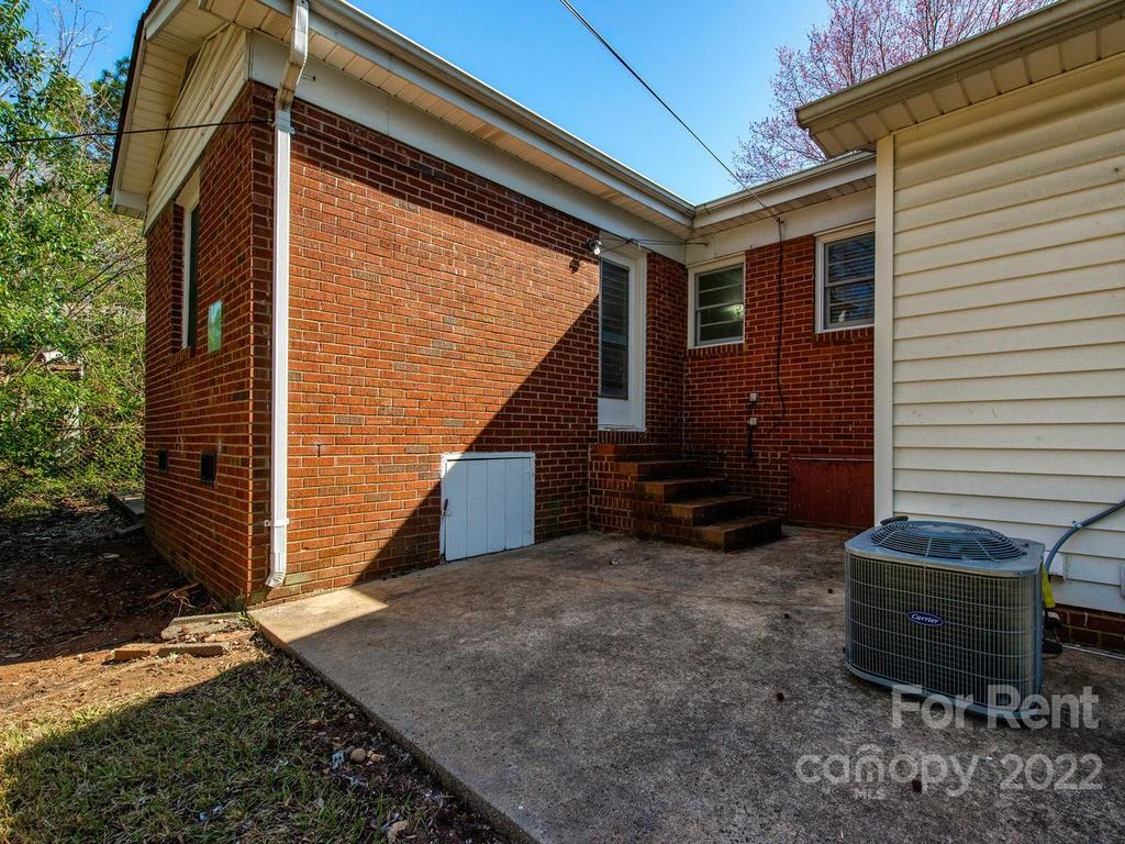943 B Norland Road, Unit B Charlotte, NC 28205 - Photo 17 of 17 a view of a house with a yard and wooden fence