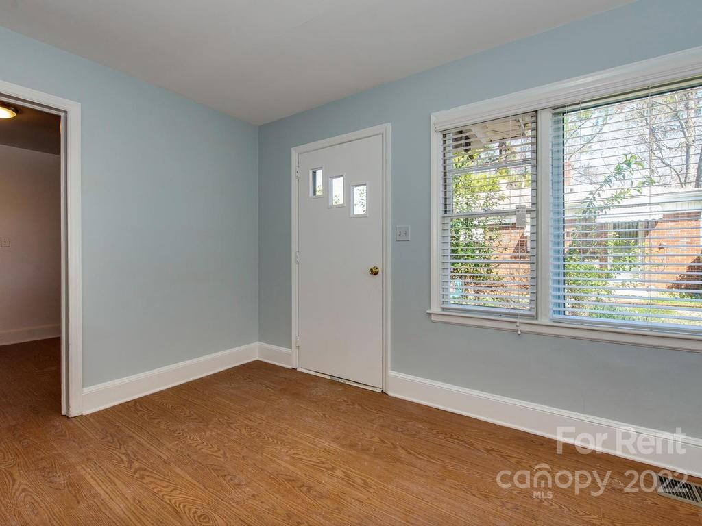 943 B Norland Road, Unit B Charlotte, NC 28205 - Photo 3 of 17 a view of an empty room with wooden floor and a window