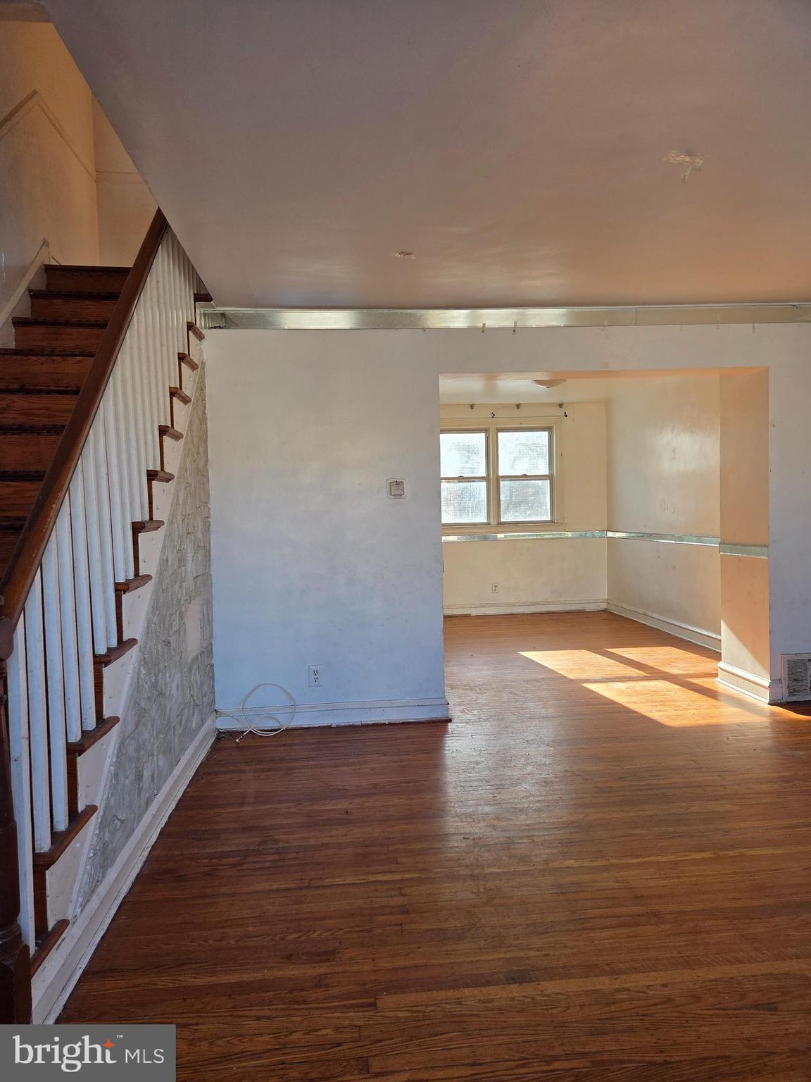 2912 Passmore Street Philadelphia, PA 19149 - Photo 3 of 13 an empty room with wooden floor and windows