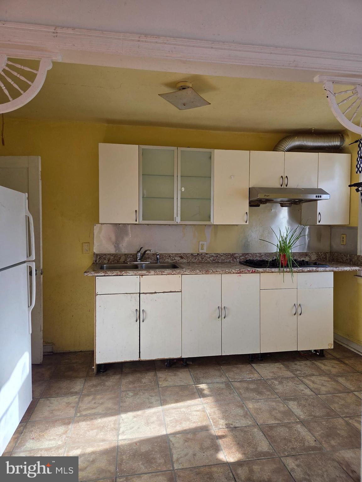 2912 Passmore Street Philadelphia, PA 19149 - Photo 5 of 13 a kitchen with a sink and cabinets