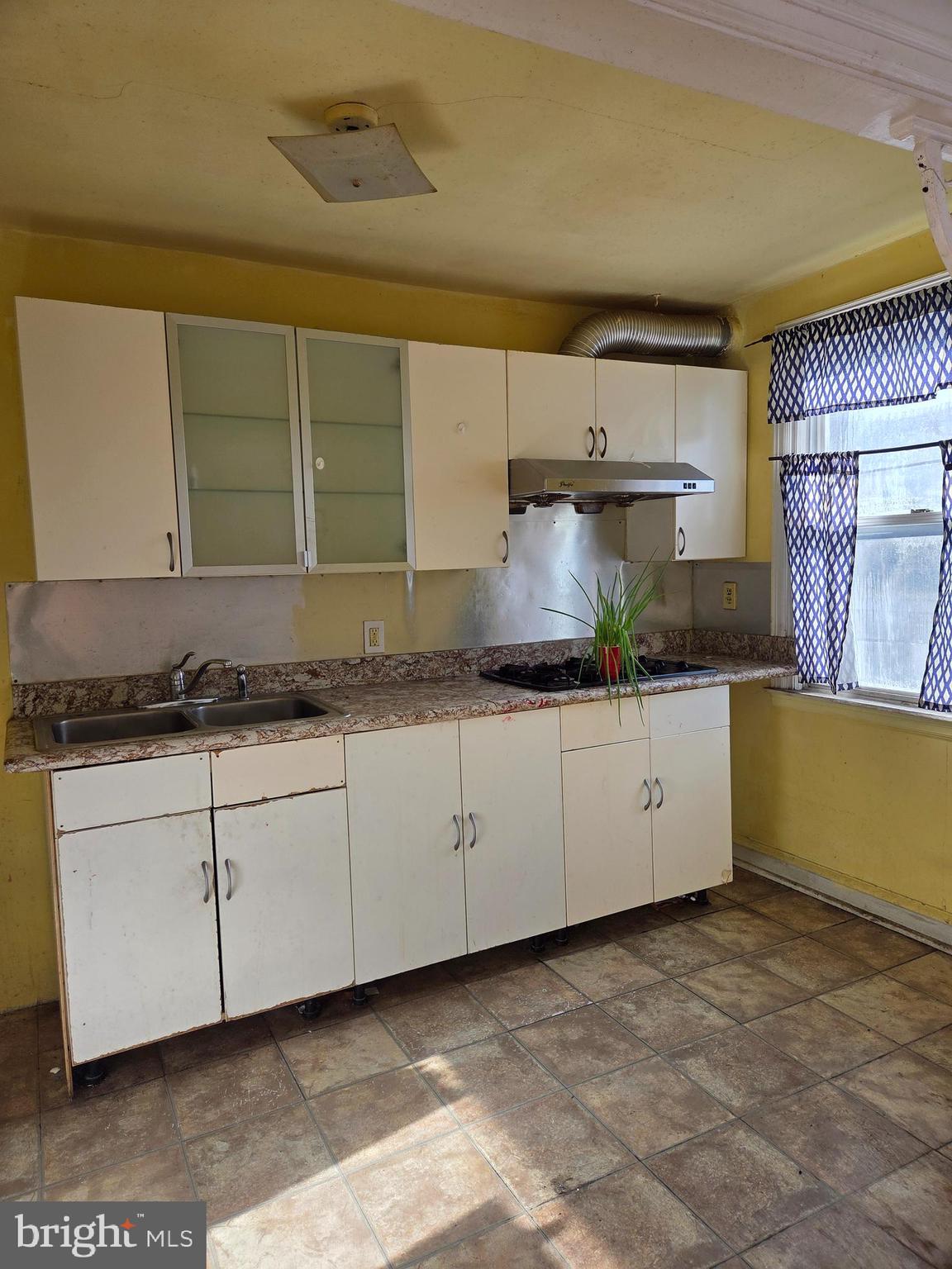 2912 Passmore Street Philadelphia, PA 19149 - Photo 6 of 13 a kitchen with granite countertop a sink and a stove