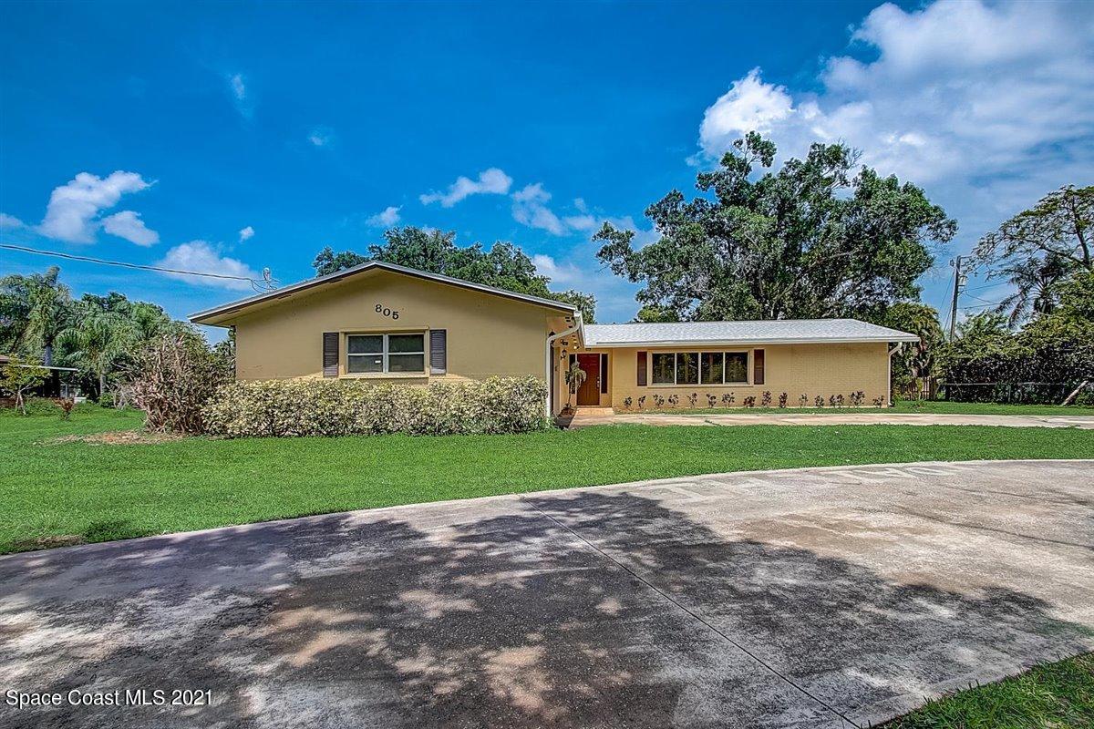 805 Knecht Road Northeast Palm Bay, FL 32905 - Photo 1 of 42 a view of a house with a yard and a garage