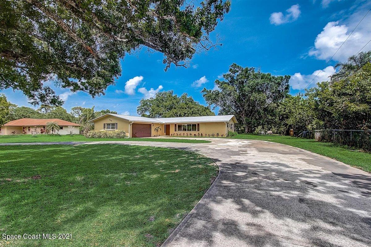 805 Knecht Road Northeast Palm Bay, FL 32905 - Photo 2 of 42 a front view of a house with garden