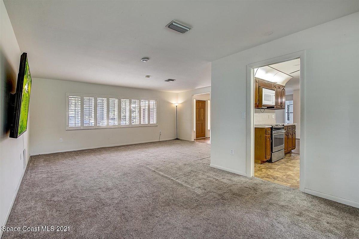 805 Knecht Road Northeast Palm Bay, FL 32905 - Photo 12 of 42 a view of an empty room with a window and fireplace
