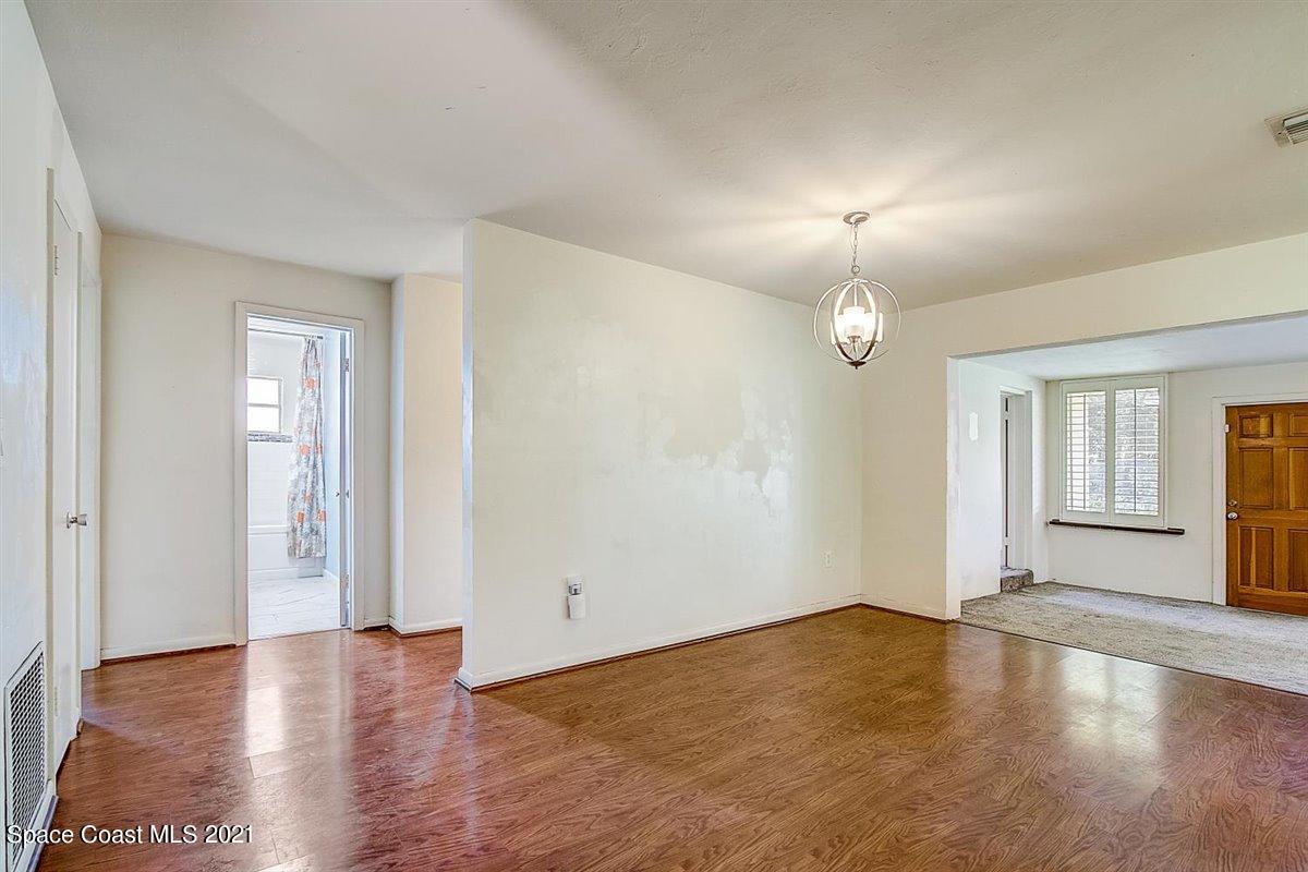 805 Knecht Road Northeast Palm Bay, FL 32905 - Photo 14 of 42 an empty room with wooden floor and window