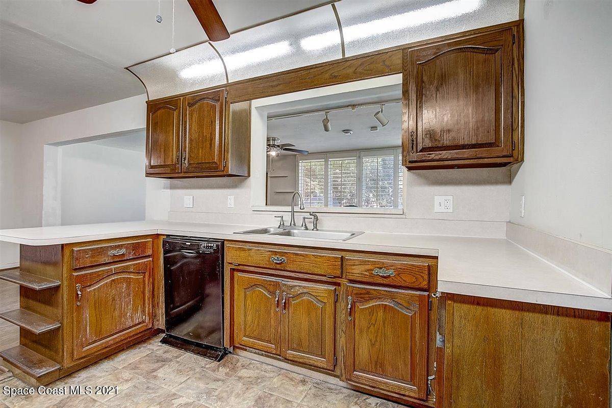 805 Knecht Road Northeast Palm Bay, FL 32905 - Photo 17 of 42 a kitchen with stainless steel appliances granite countertop cabinets and window