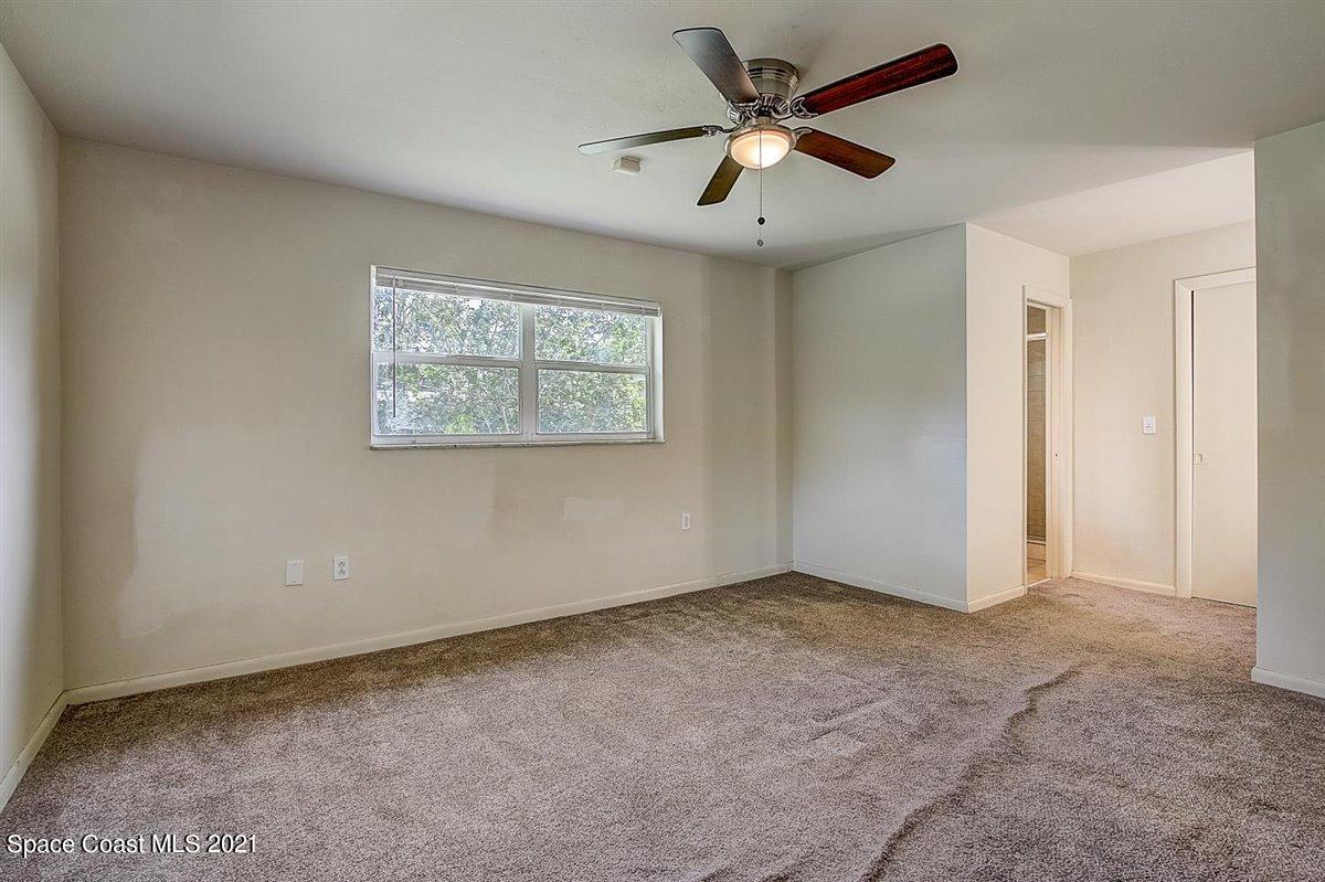 805 Knecht Road Northeast Palm Bay, FL 32905 - Photo 18 of 42 an empty room with windows and fan