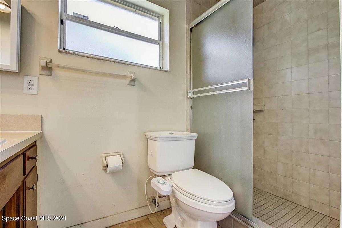 805 Knecht Road Northeast Palm Bay, FL 32905 - Photo 22 of 42 a white toilet sitting next to a bathroom sink