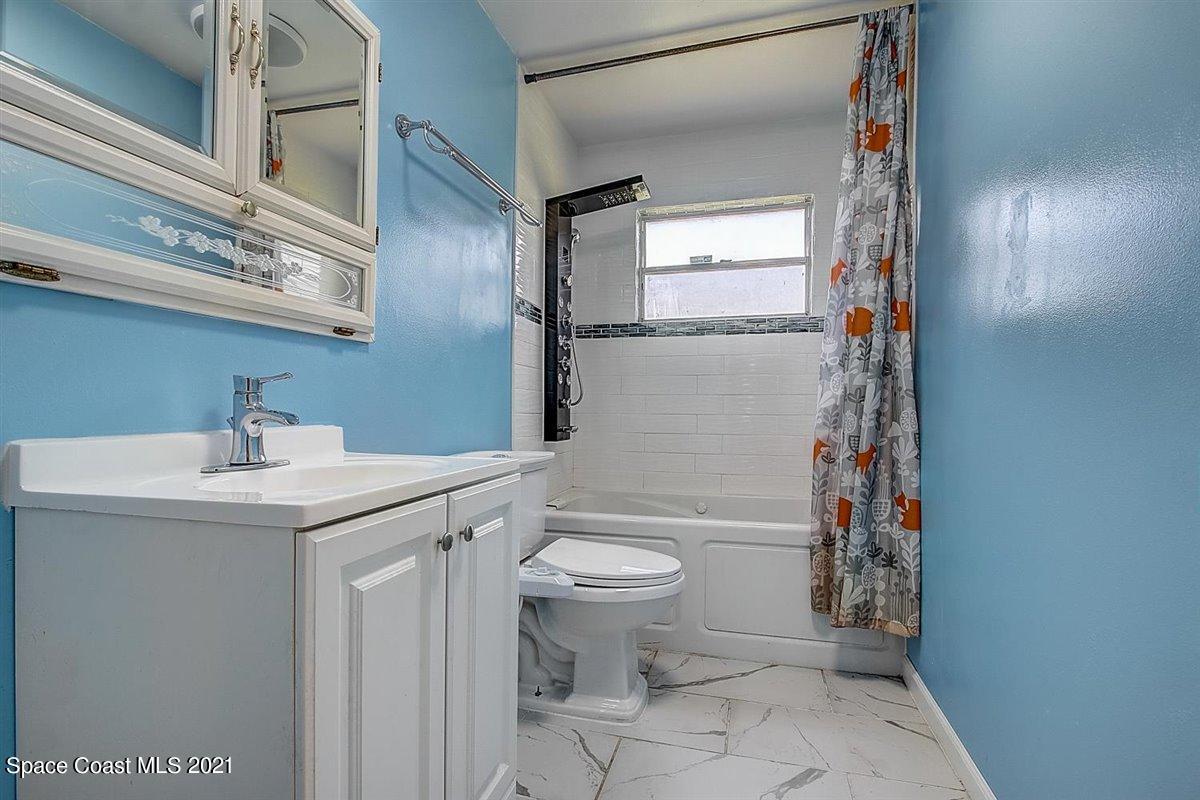 805 Knecht Road Northeast Palm Bay, FL 32905 - Photo 27 of 42 a bathroom with a sink a toilet and shower