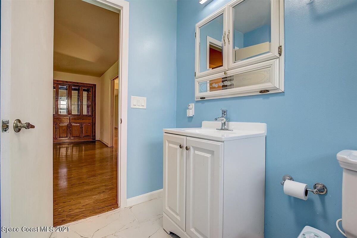 805 Knecht Road Northeast Palm Bay, FL 32905 - Photo 28 of 42 a bathroom with a sink a toilet and shower