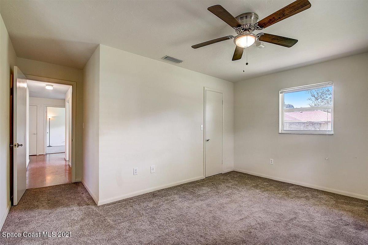 805 Knecht Road Northeast Palm Bay, FL 32905 - Photo 31 of 42 an empty room with a ceiling fan and a window