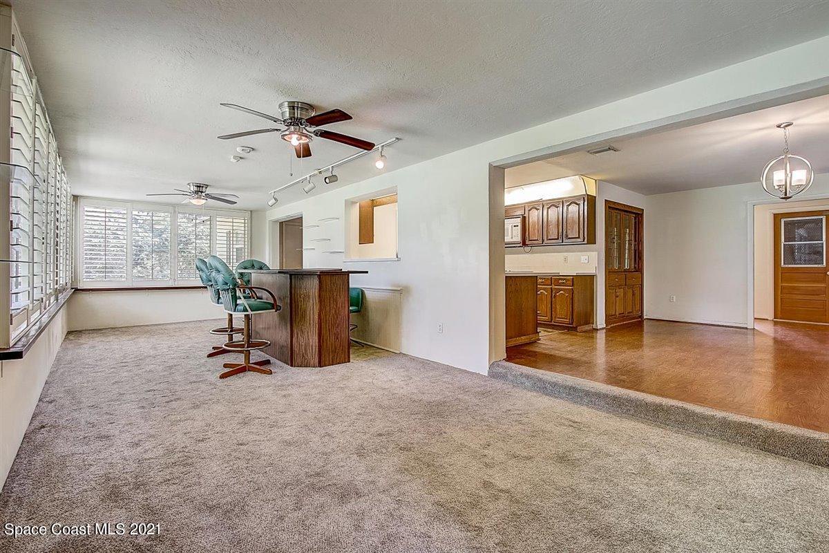 805 Knecht Road Northeast Palm Bay, FL 32905 - Photo 32 of 42 a view of a livingroom with furniture and a ceiling fan