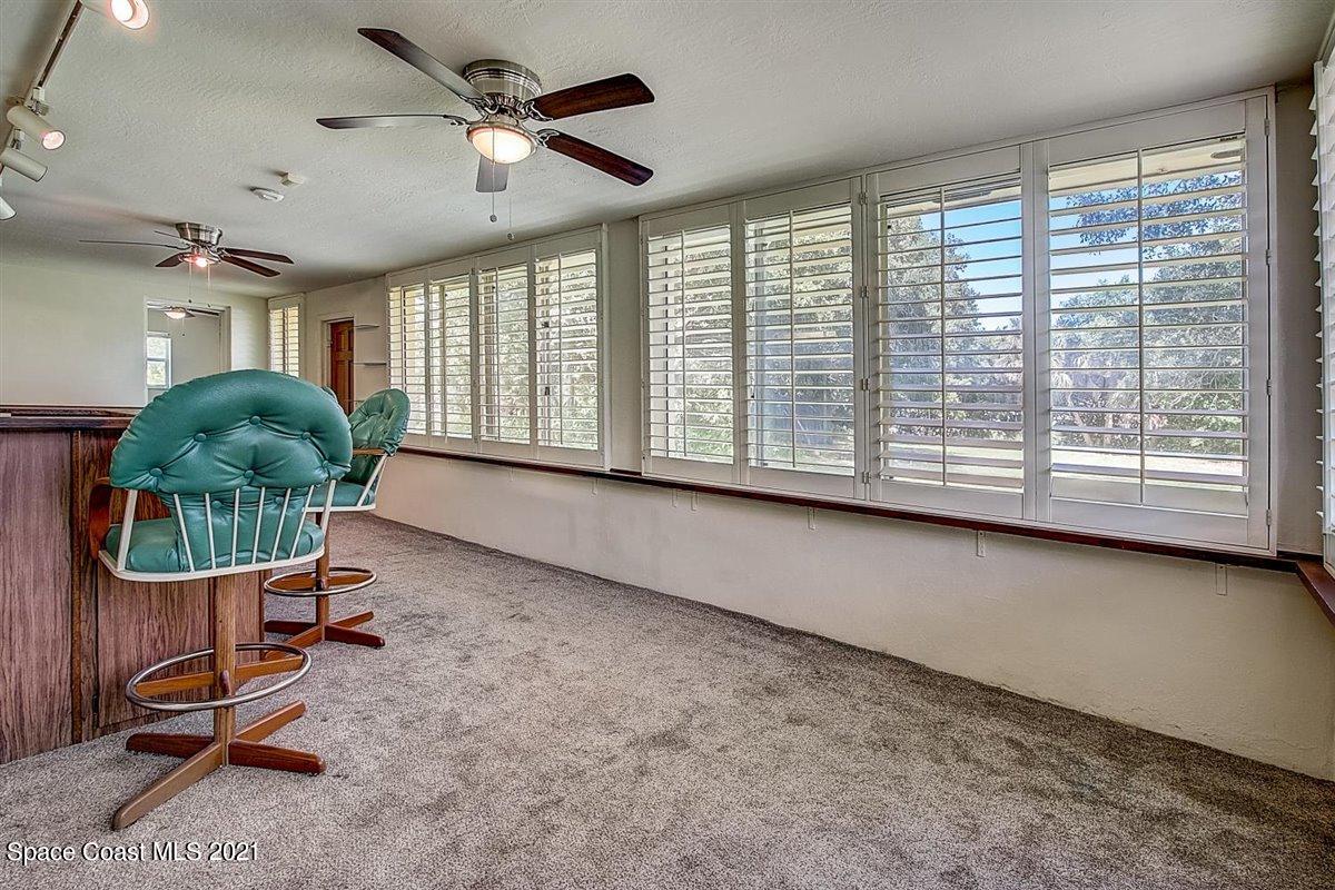805 Knecht Road Northeast Palm Bay, FL 32905 - Photo 34 of 42 a living room with furniture and a large window