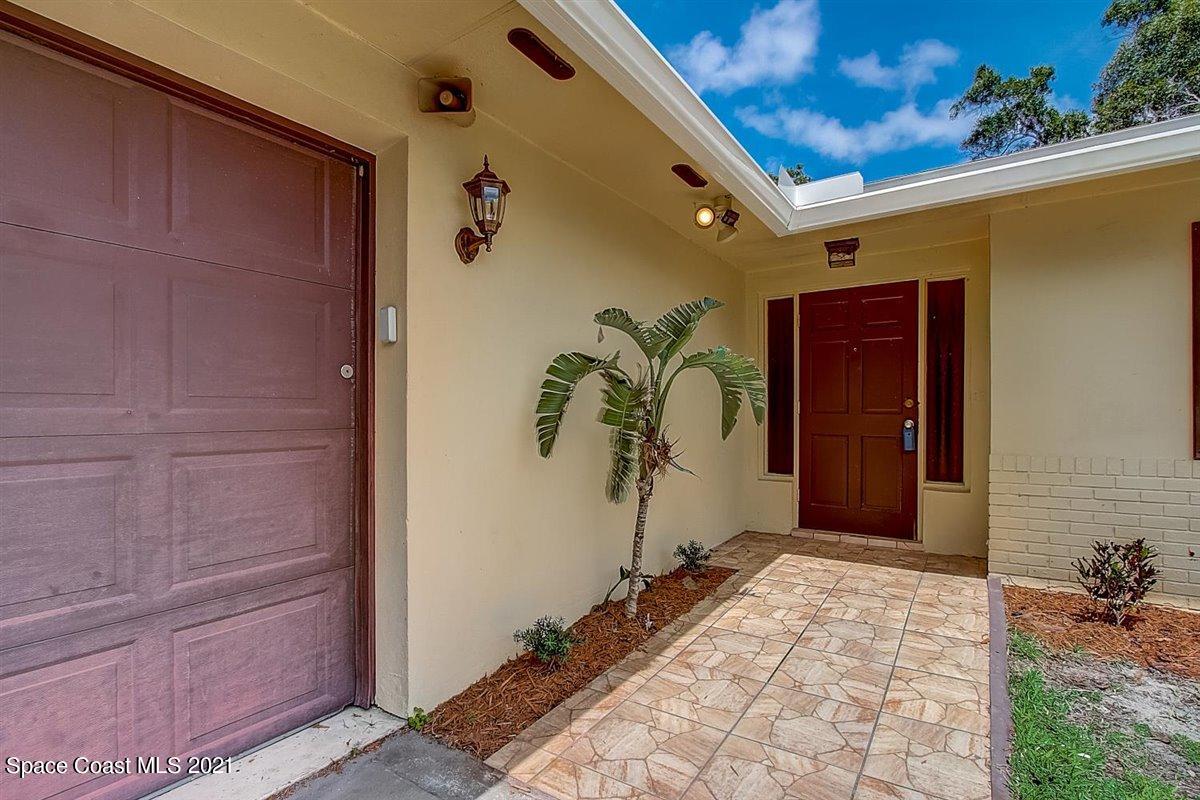 805 Knecht Road Northeast Palm Bay, FL 32905 - Photo 5 of 42 a view of a entryway door front of a house