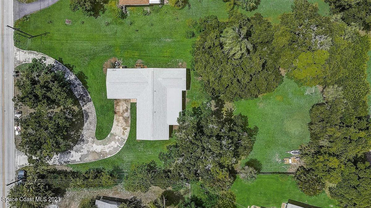805 Knecht Road Northeast Palm Bay, FL 32905 - Photo 42 of 42 an aerial view of a house with outdoor space and lake view