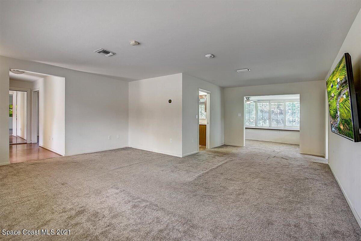 805 Knecht Road Northeast Palm Bay, FL 32905 - Photo 10 of 42 a view of a big room with windows and chandelier