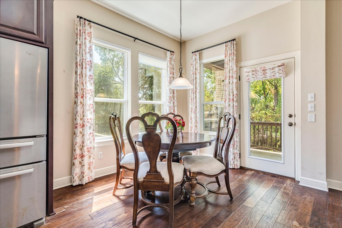 12909 Medina River Way Austin, TX 78732 - Photo 20 of 36 Custom drapes and bright windows with a glass-paneled back door in this cozy dining space.