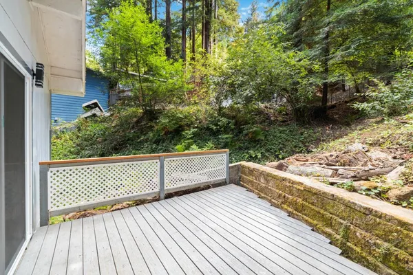 a view of a house with a wooden deck