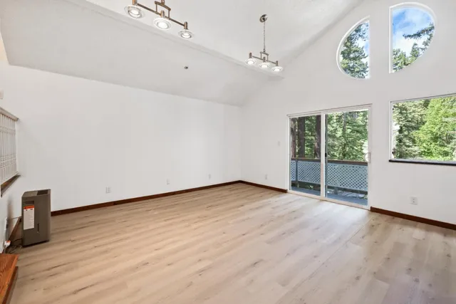 a kitchen with stainless steel appliances granite countertop a sink a stove and a wooden floors