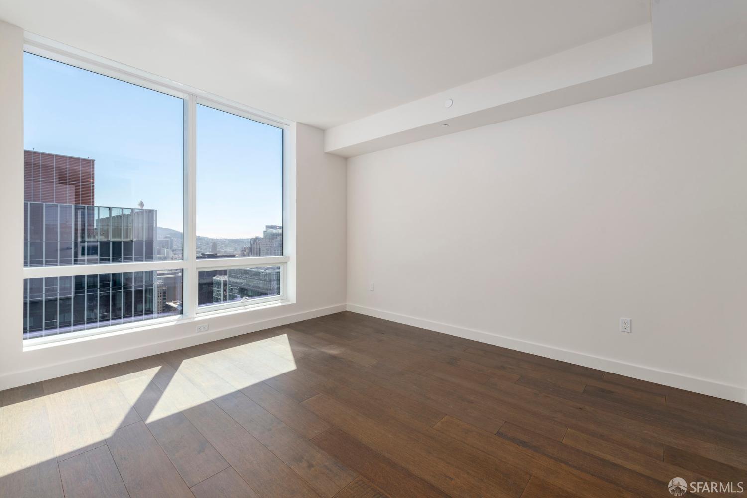 488 Folsom Street, Unit 4305 San Francisco, CA 94105 - Photo 11 of 45 wooden floor in an empty room with a window